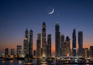 Alt="Crescent moon over Dubai skyline marking Eid Al Fitr 2026 UAE AI-generated illustration"